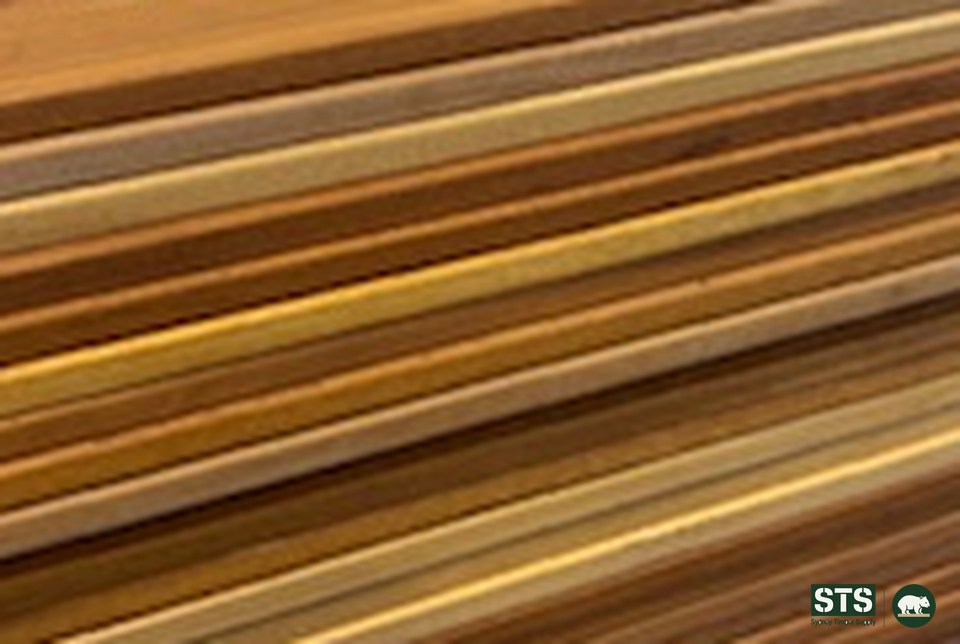 Stacked 140 x 19 Peninsula Blonde hardwood decking boards viewed along their length, showing honey to dark brown colour variation between boards