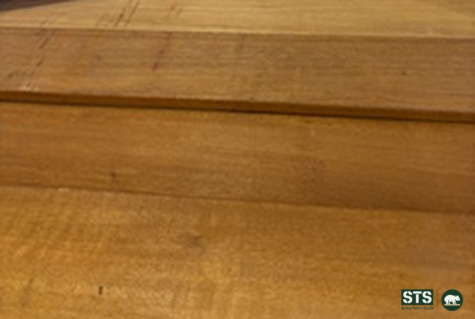 Close view of the face of 140 x 19 Peninsula Blonde hardwood decking boards showing surface grain and a square edge with a slight pencil round